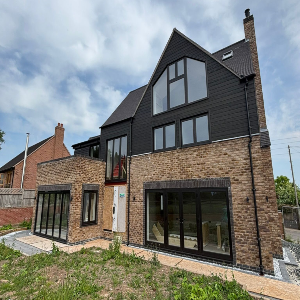 New build on brownfield site has air source heat pump as they are heavily favored over gas boilers for heating systems on new builds to meet low-carbon requirements.